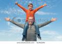 8796stock-photo-a-boy-is-sitting-on-his-father-s-neck-holding-his-thumbs-up-61462246.
